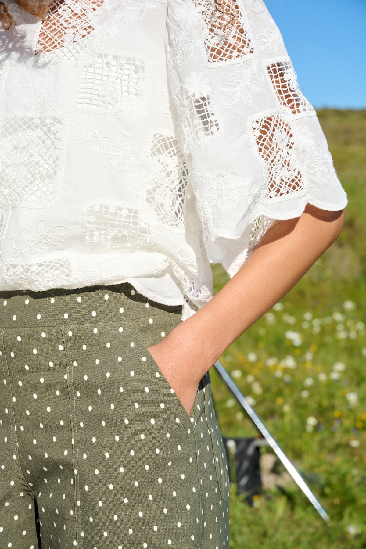 Model wearing fatigue green polka dot wide-leg pants with patch pockets