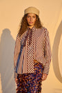Model wearing chocolate and milk striped oversized button-up shirt