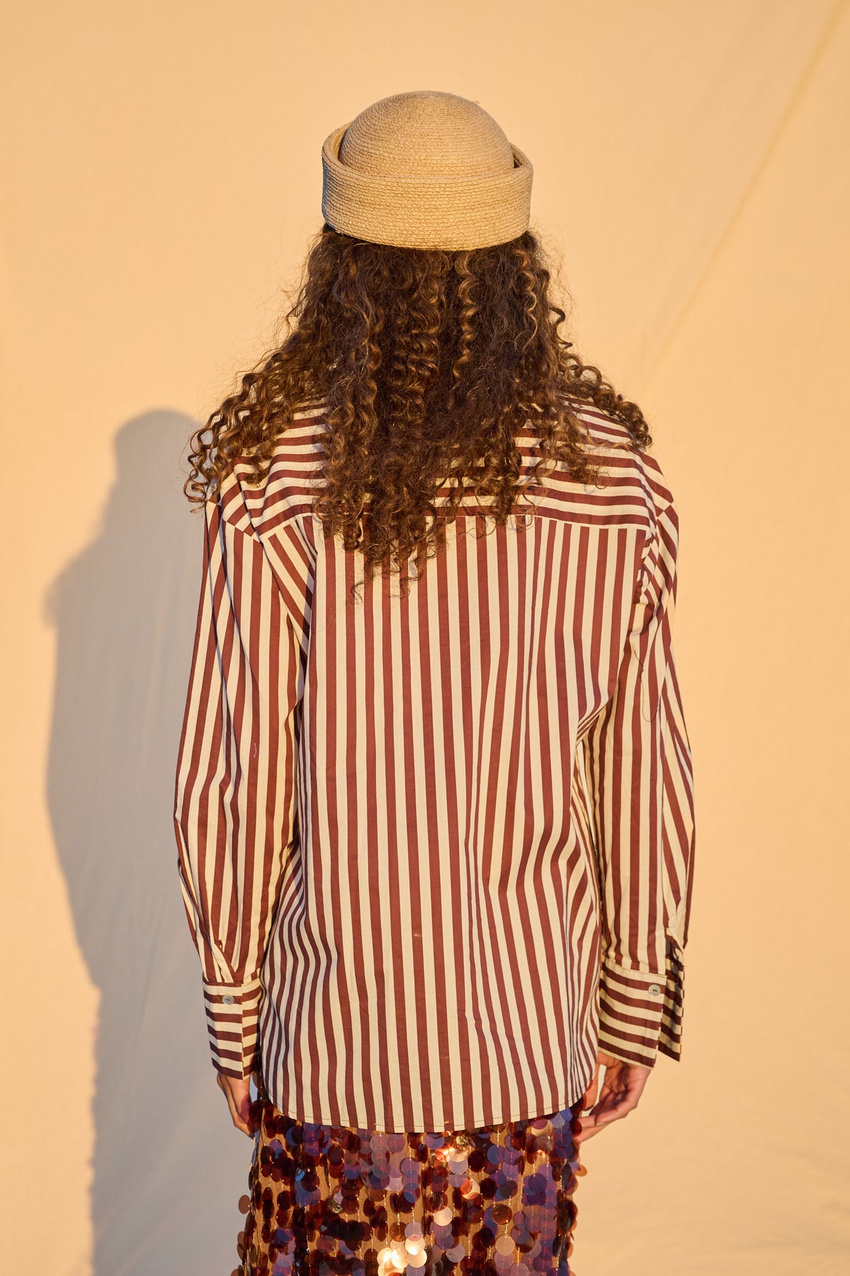 Model wearing chocolate and milk striped oversized button-up shirt
