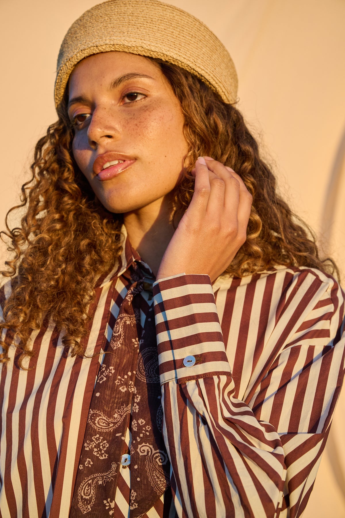 Close-up of chocolate and milk striped shirt with paisley necktie
