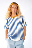 Model wearing a striped Tee with Egg embroidery 