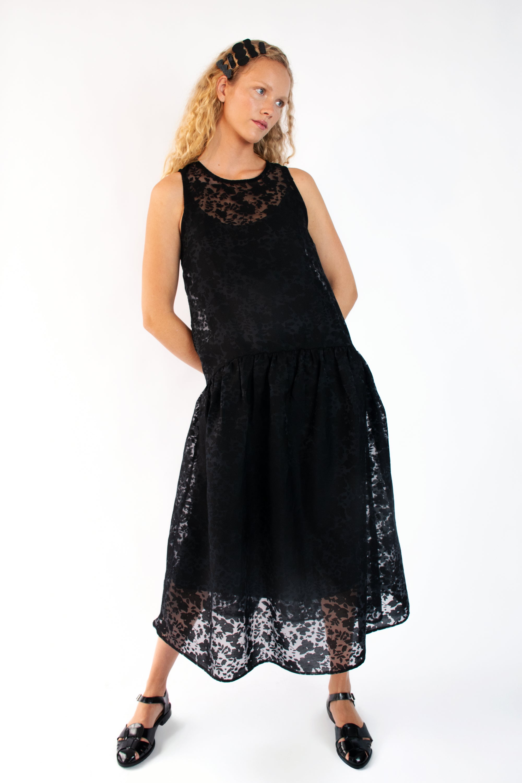 Model wearing black organza drop waist dress