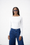 Model is wearing a white long sleeve boat neck in white