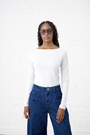Model is wearing a white long sleeve boat neck in white