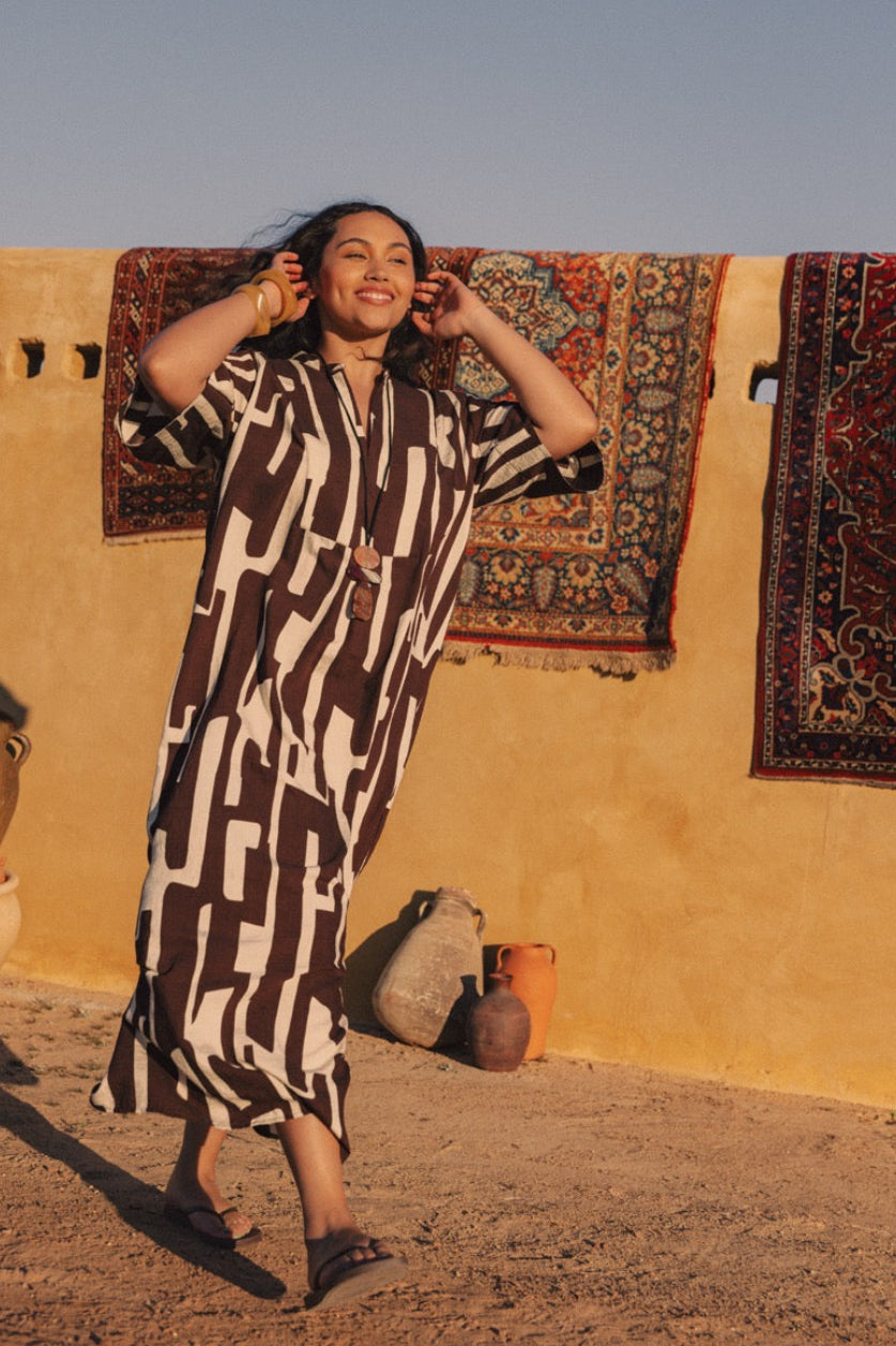 Model wearing chocolate banana-print rayon bib-front maxi tunic