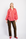 Model wearing pink and red striped shirt with animal print pants and red shoes